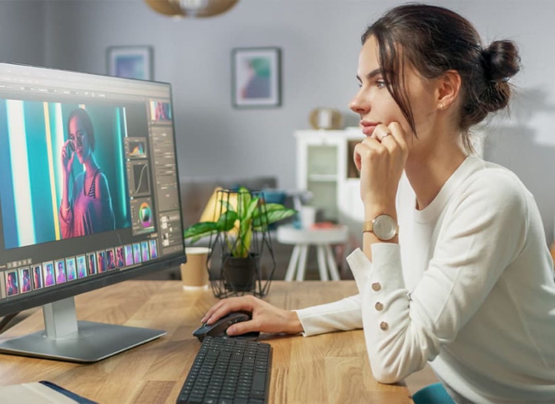 woman video editing on monitor