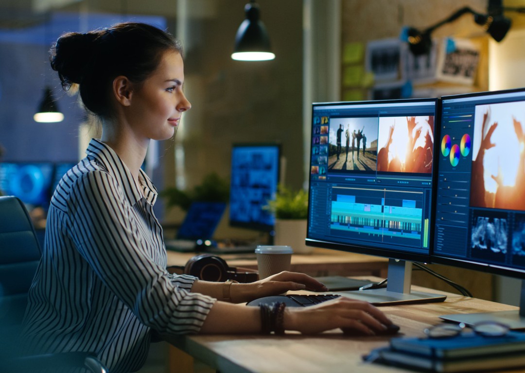 woman video editing at desk