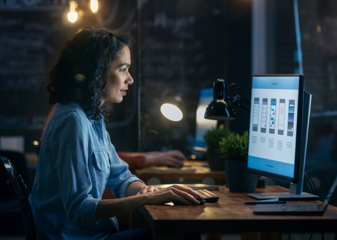 woman working at desk with monitor